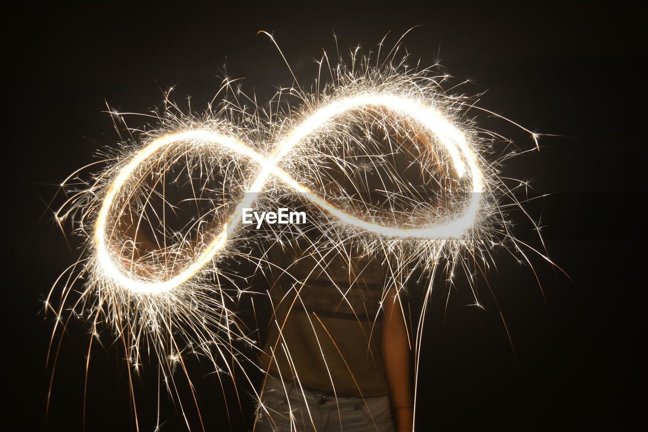 Person playing with sparkler