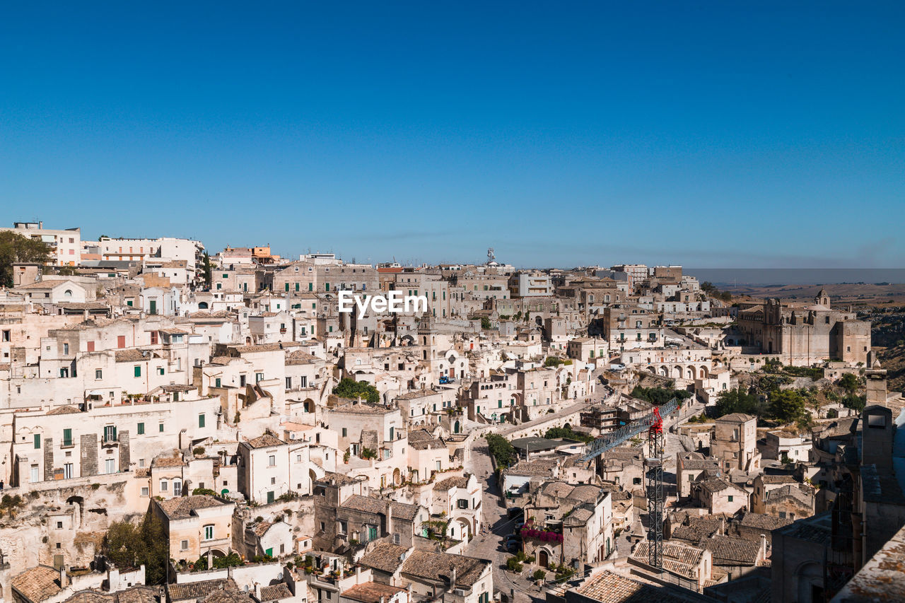 Matera, italy. aerial view of townscape against clear blue sky