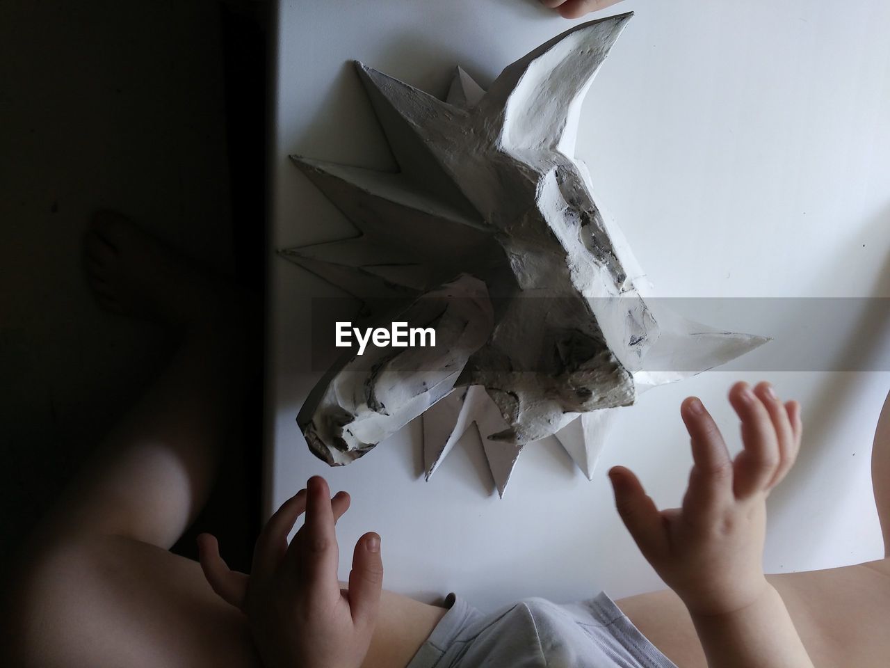 Close-up of child hand with clay art on table