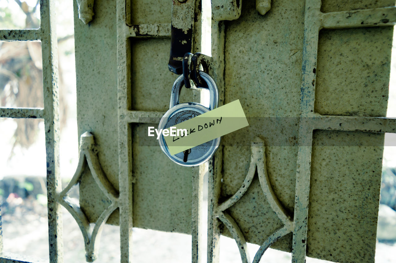 Close-up of information sign hanging padlocks. covid lockdown corona virus themes