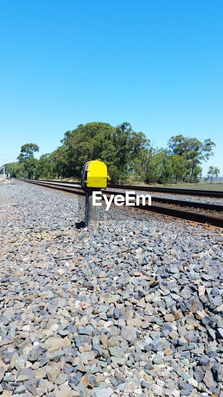 LOW ANGLE VIEW OF RAILROAD TRACK AGAINST SKY