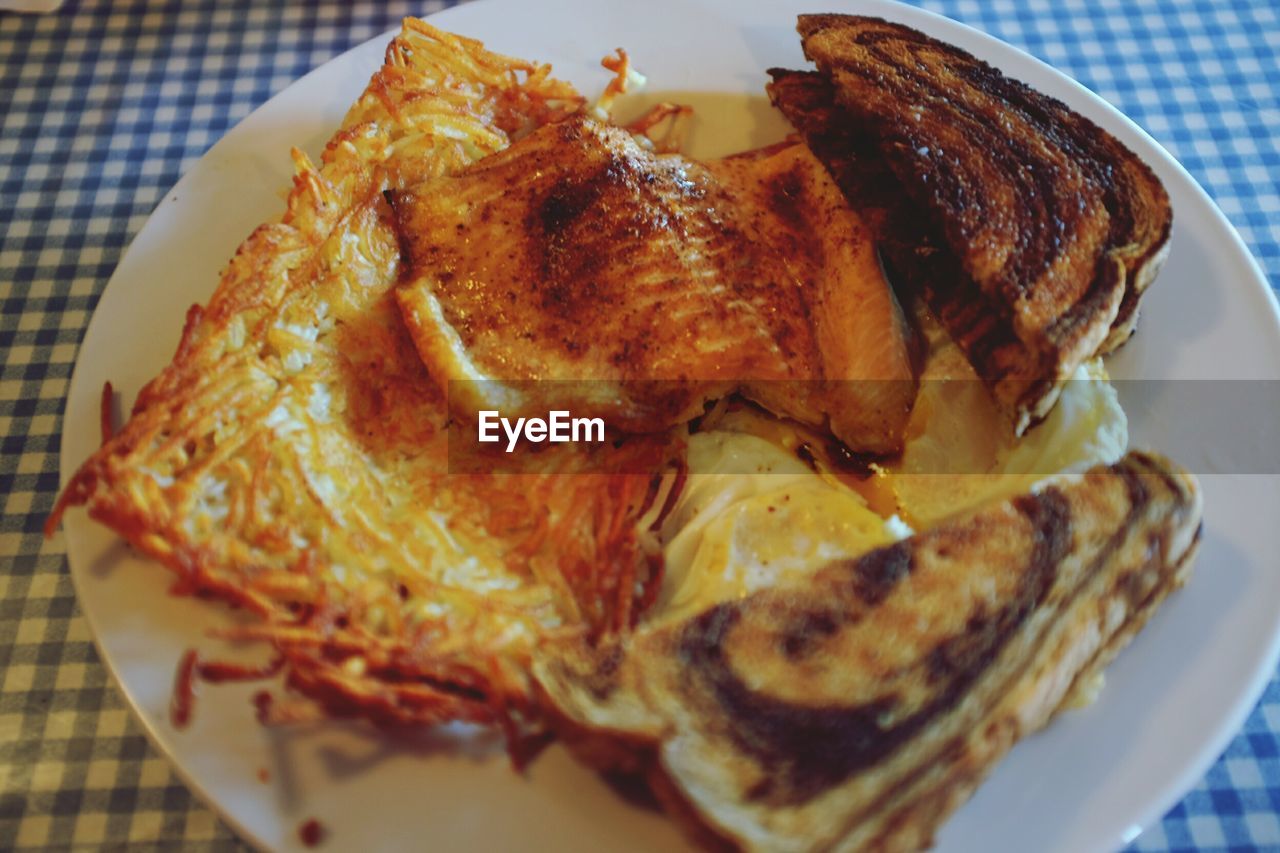 Close-up of trout and eggs served on table