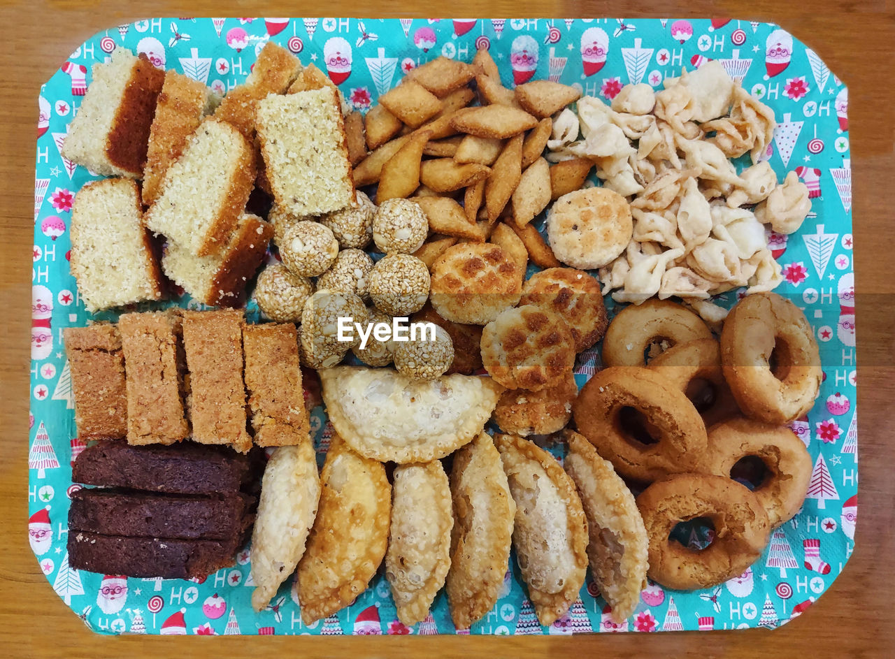 food and drink, food, freshness, dessert, cookies and crackers, cookie, snack, baked, sweet food, directly above, indoors, no people, dish, sweet, still life, table, high angle view, temptation, large group of objects, plate, produce, wood, shape, variation