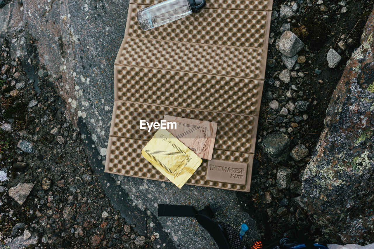 High angle view of water bottle on mat at ground