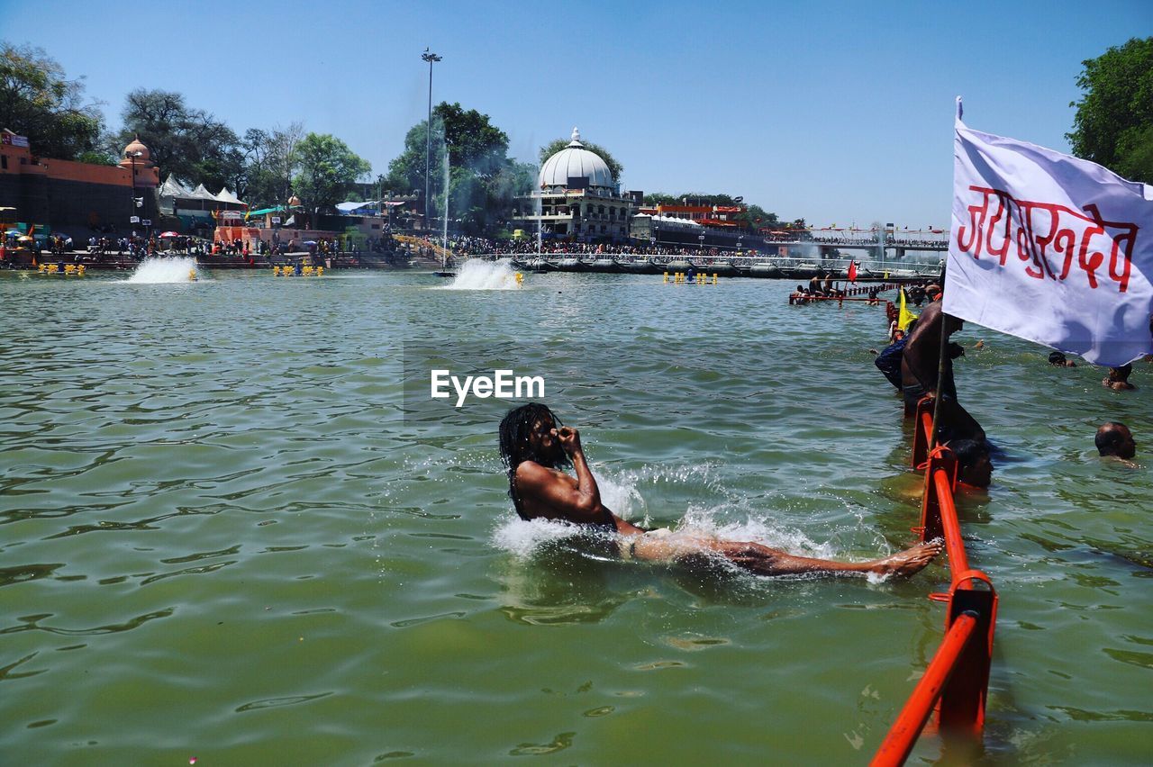 PEOPLE IN BOAT IN SEA