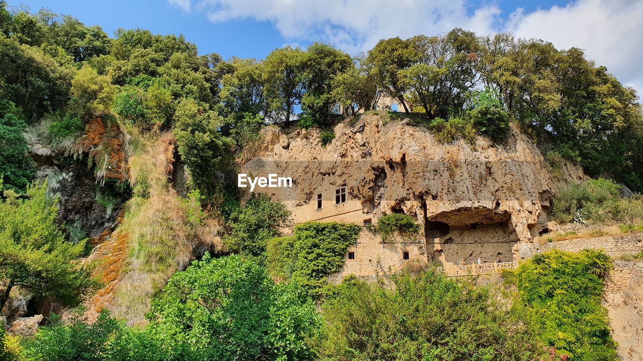 plant, tree, nature, sky, architecture, ruins, land, travel destinations, no people, landscape, history, cloud, travel, scenics - nature, ancient, environment, built structure, beauty in nature, rock, growth, the past, green, outdoors, mountain, tourism, day, non-urban scene, building, tranquility, building exterior, rural area, old ruin, village, flower, ancient history, terrain, cliff