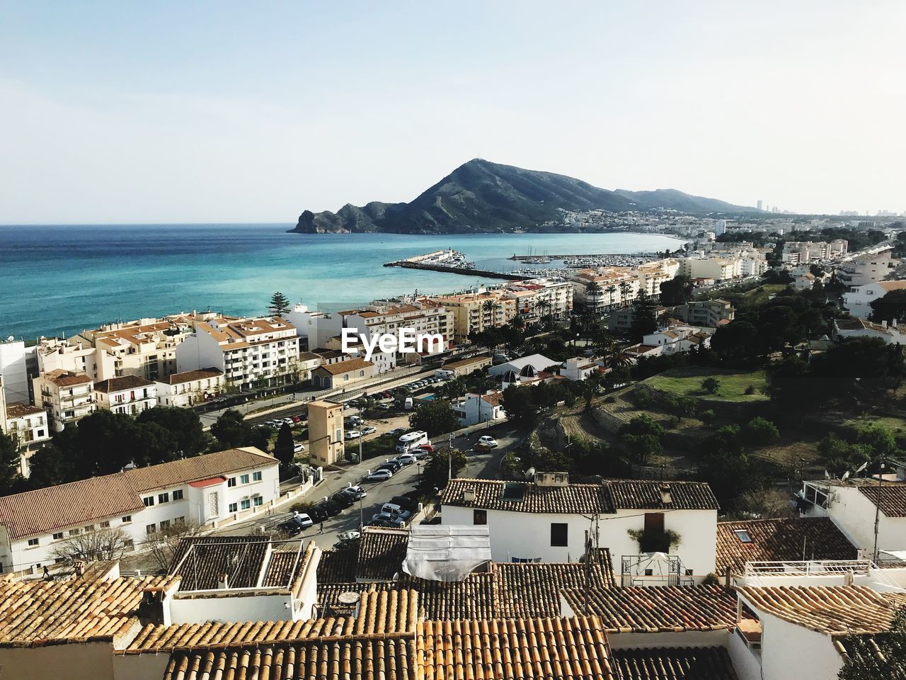 High angle view of city by sea against sky