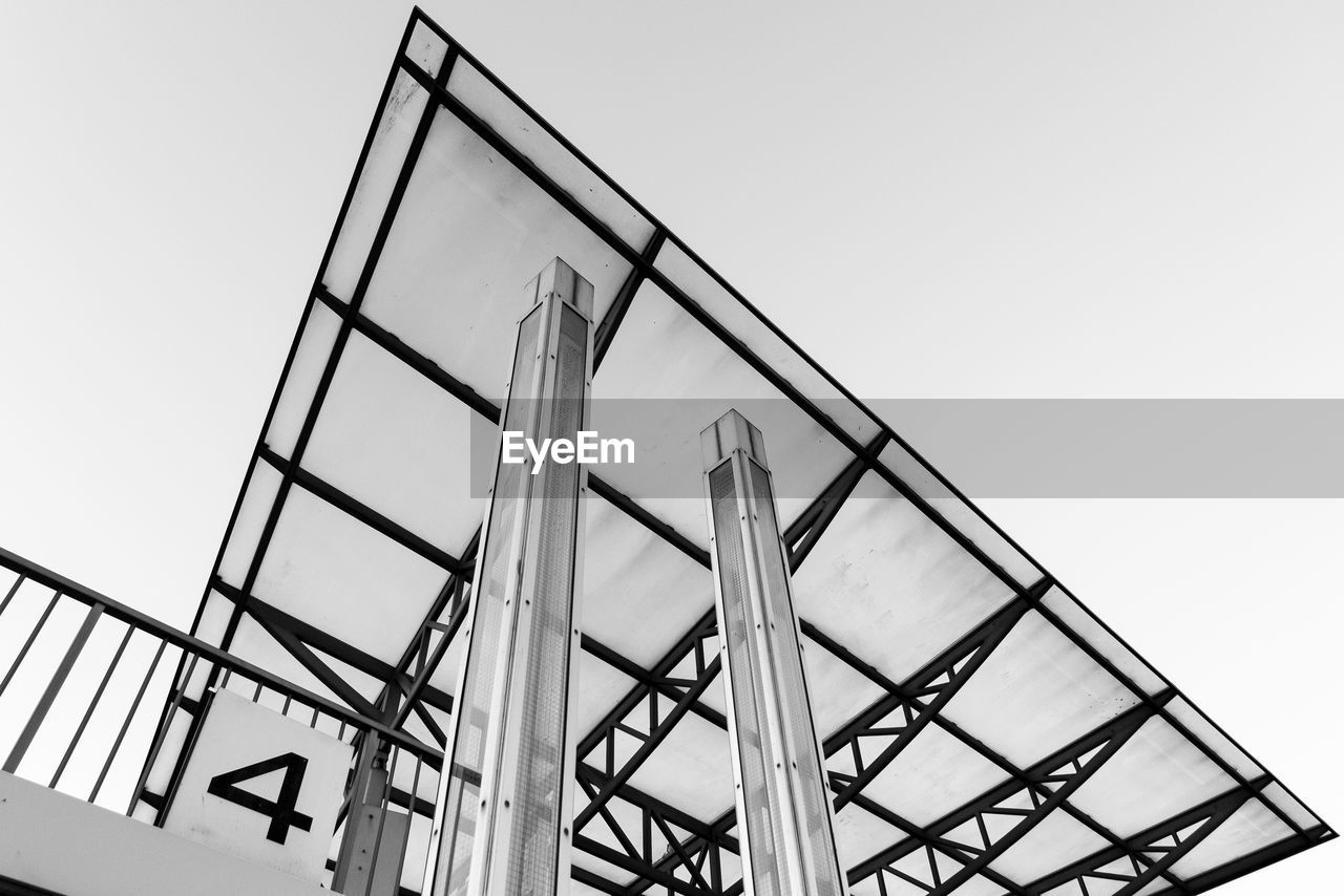 LOW ANGLE VIEW OF LADDER AGAINST BUILDING AGAINST CLEAR SKY