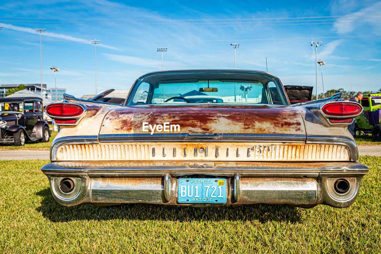 OLD CAR AGAINST BLUE SKY