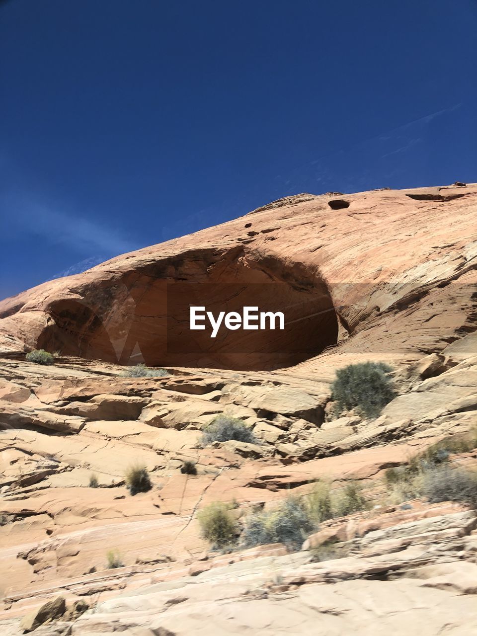 Scenic view of desert against clear blue sky