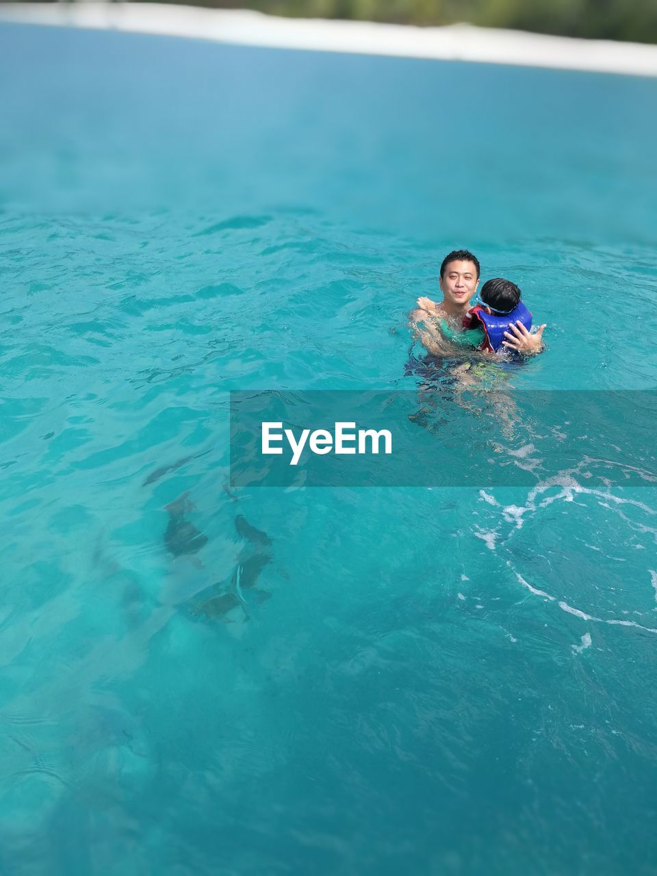 HIGH ANGLE VIEW OF WOMAN IN SWIMMING POOL