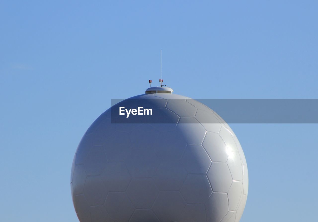 HELICOPTER AGAINST CLEAR BLUE SKY