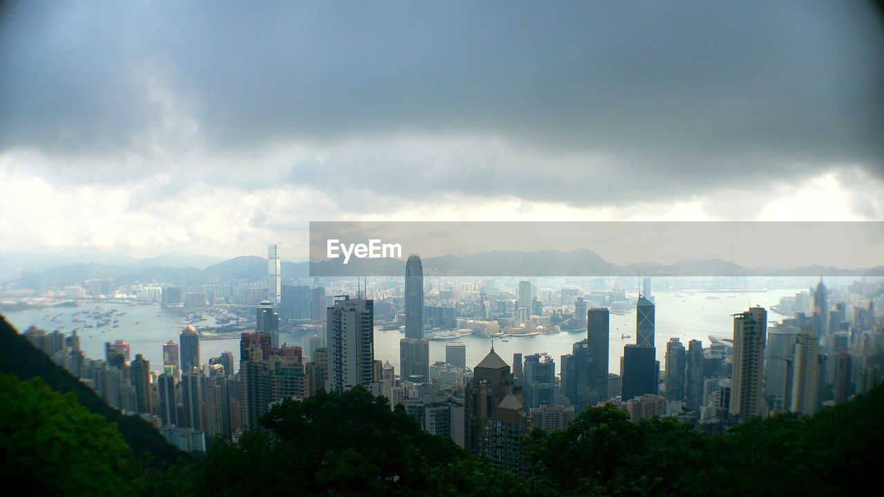 SKYSCRAPERS AGAINST CLOUDY SKY