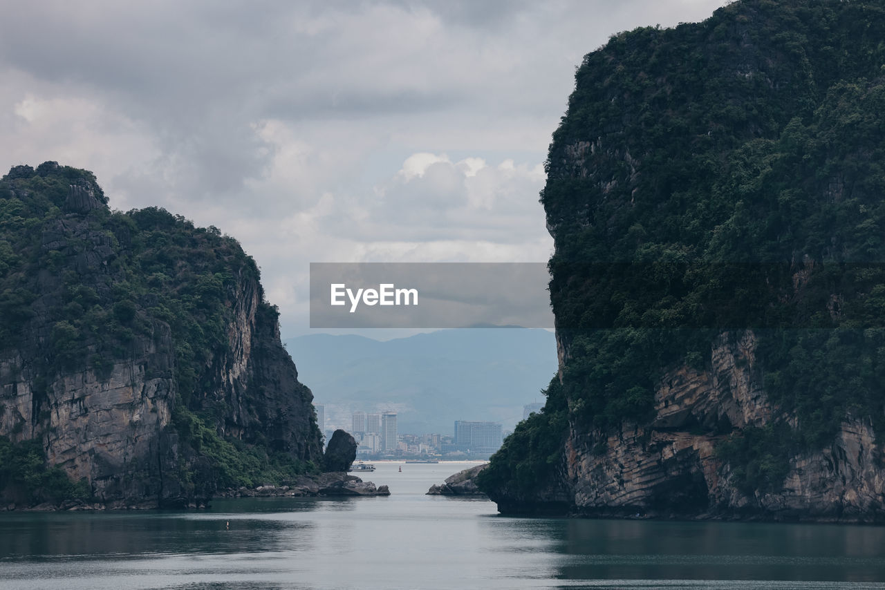 scenic view of cliff by sea against sky