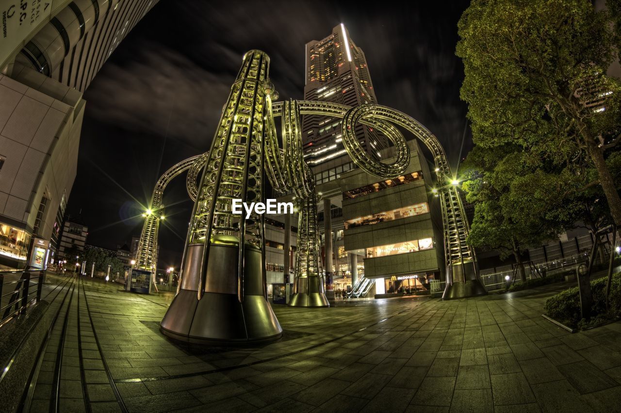 VIEW OF ILLUMINATED CITY AT NIGHT