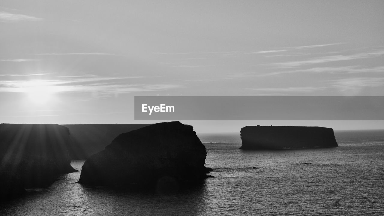 Rocks on sea against sky