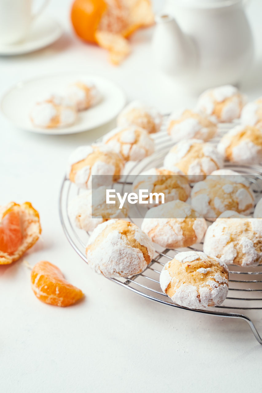 Home baked racked clementine cookies on baking rack, closeup view