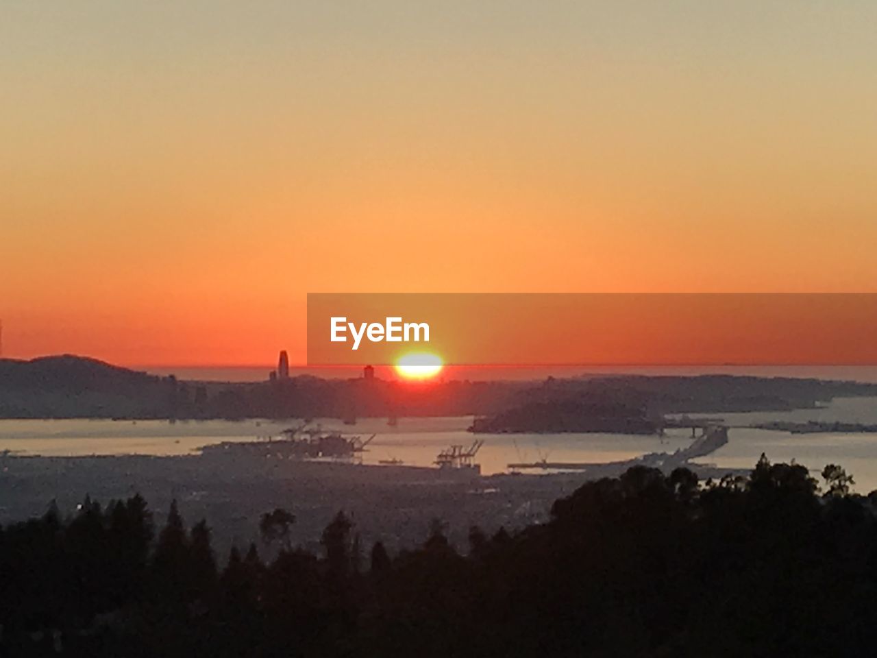 SCENIC VIEW OF SILHOUETTE LANDSCAPE AGAINST ORANGE SKY DURING SUNSET