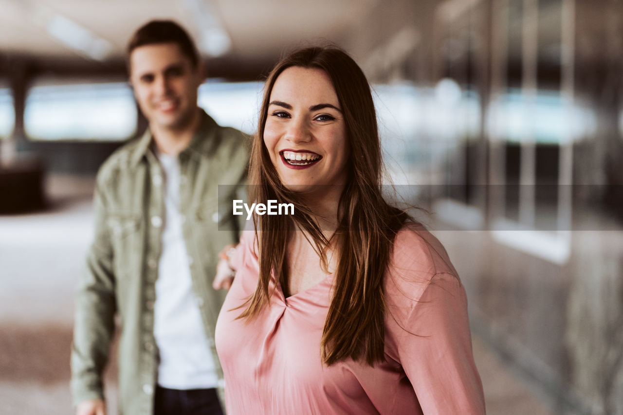 PORTRAIT OF SMILING YOUNG COUPLE