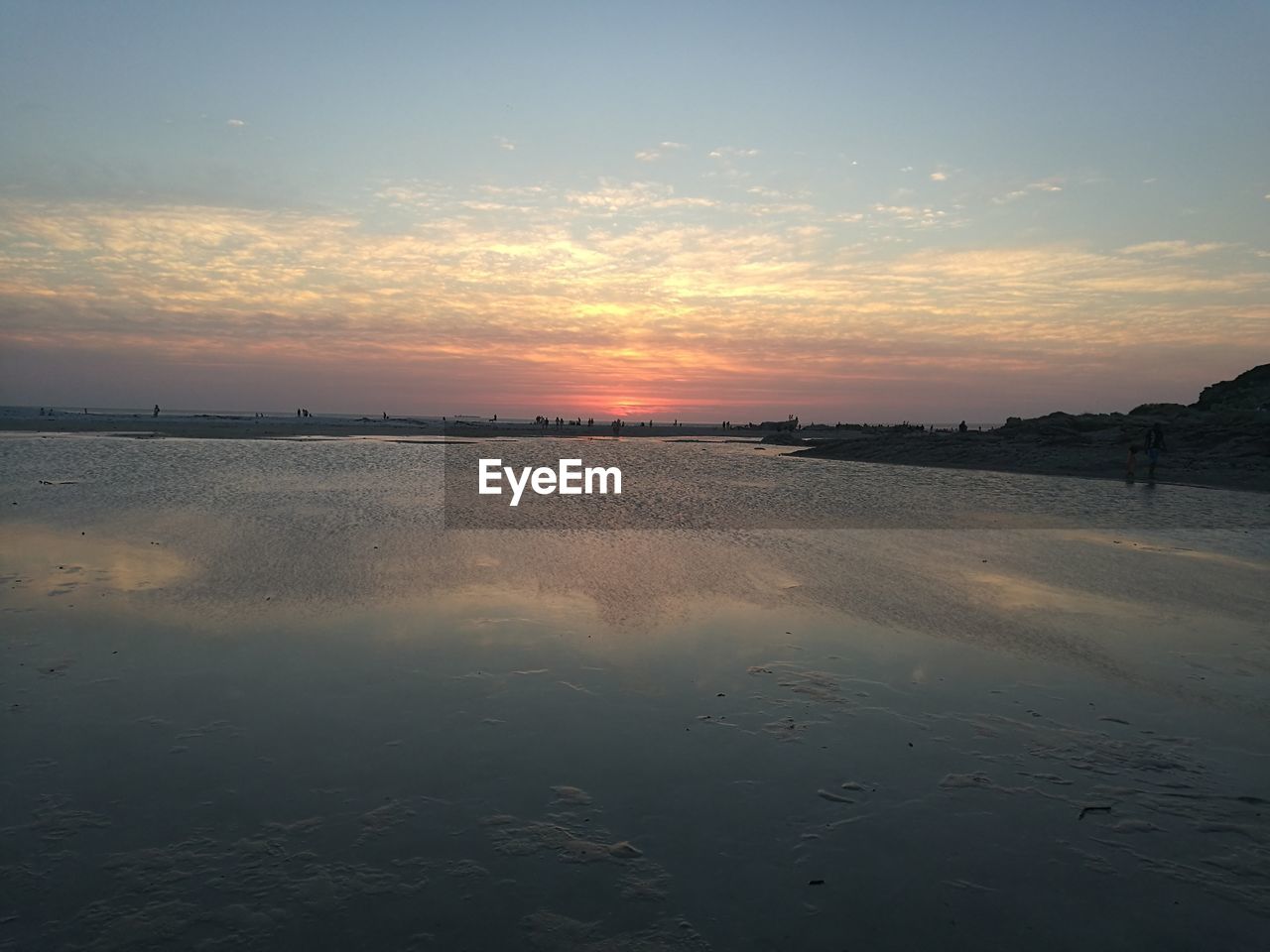 SCENIC VIEW OF BEACH AGAINST SKY AT SUNSET