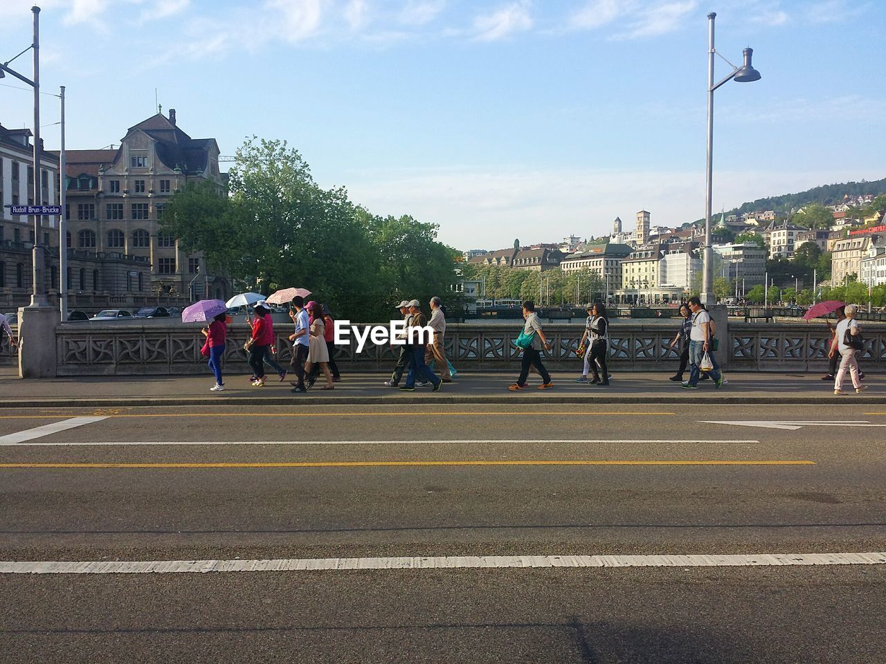 People walking on bridge in city