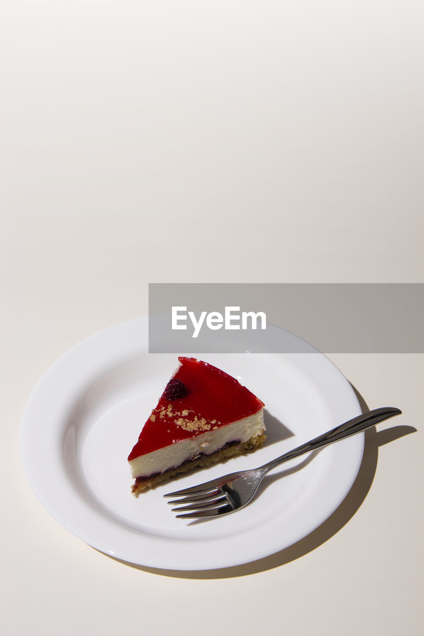 Close-up of cake on plate against white background