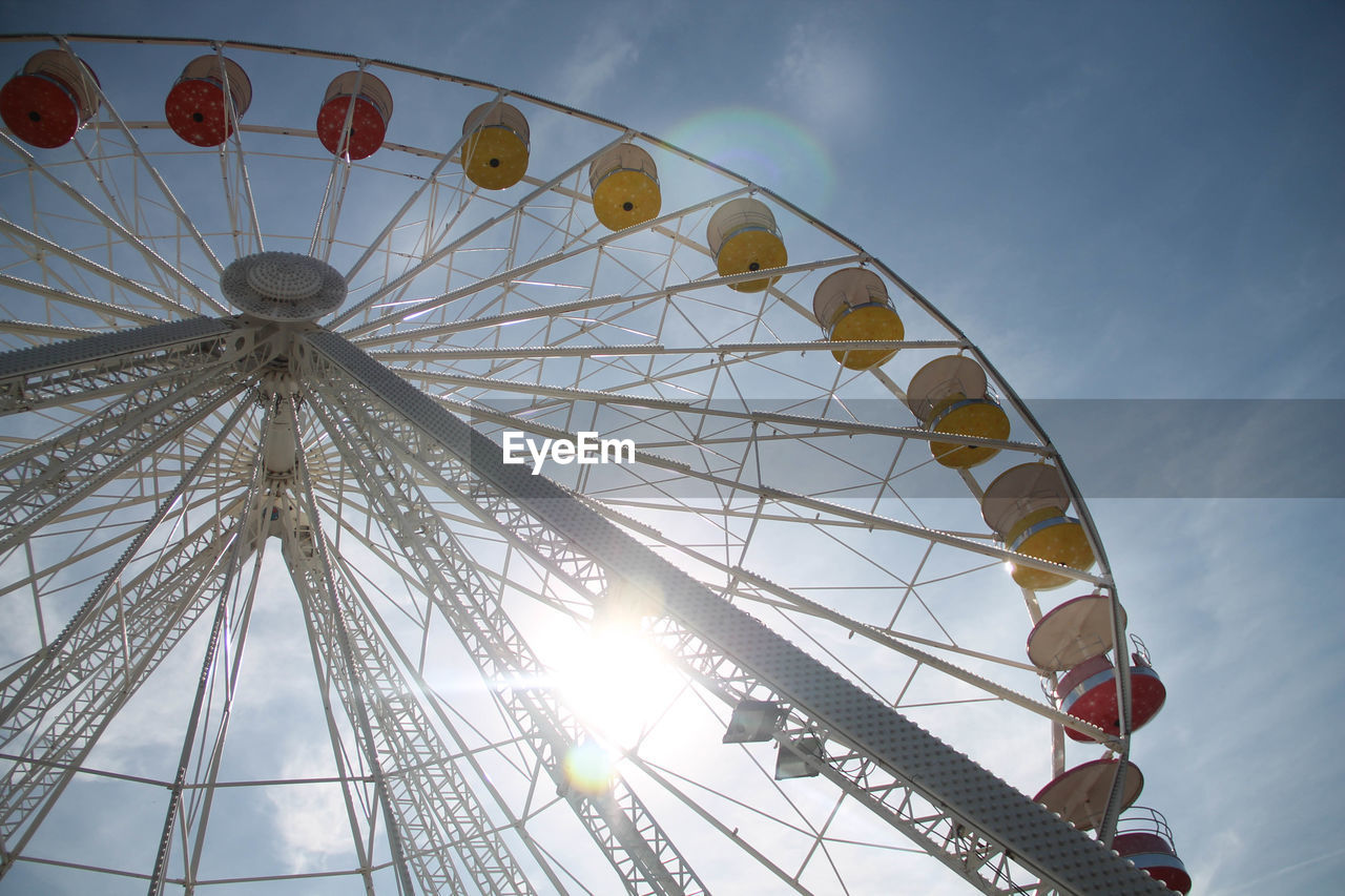 Low angle view of ferris wheel against sky