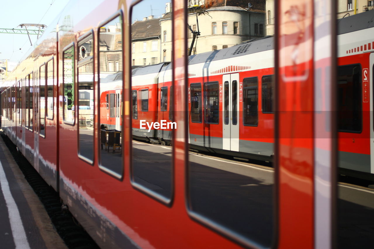 Reflection on train by platform