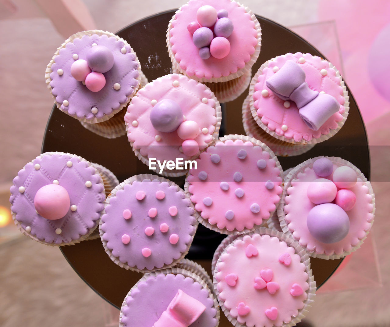 HIGH ANGLE VIEW OF PINK CUPCAKES ON TABLE