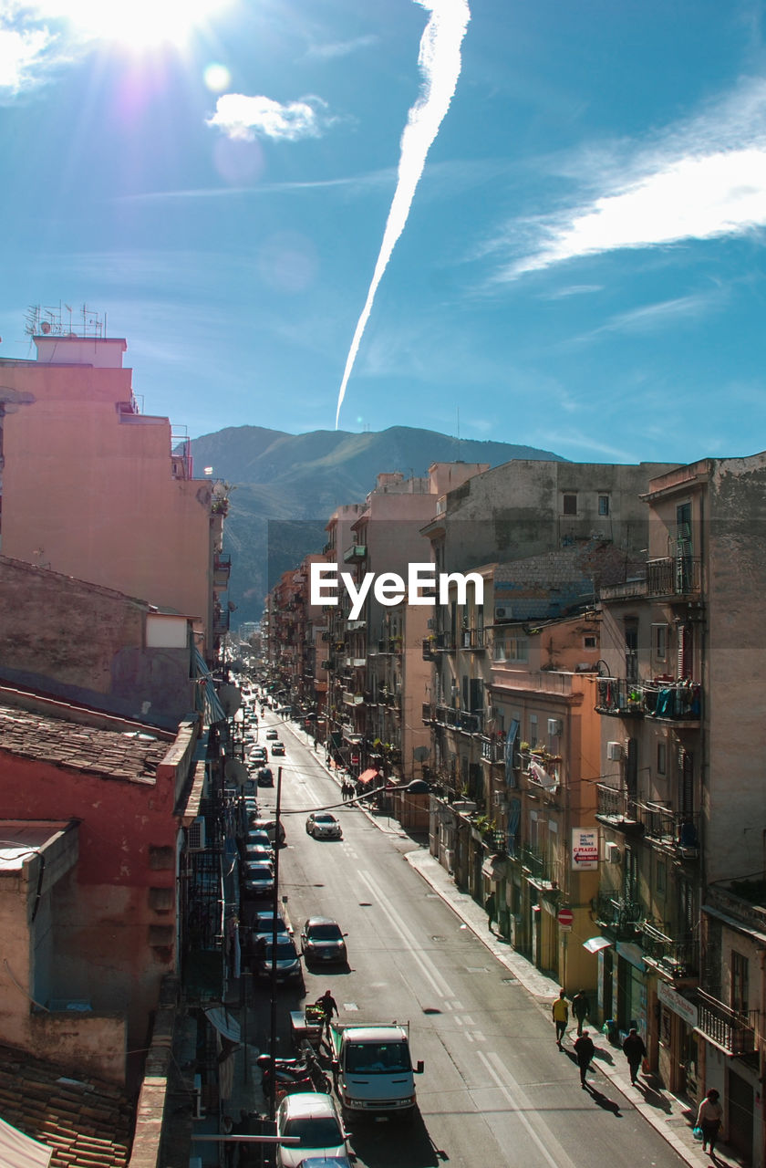 Panoramic view of city street and buildings against sky