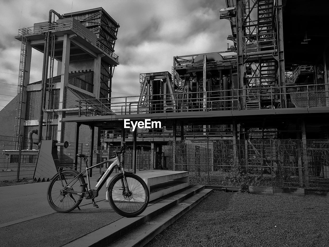 Bicycle on bridge against buildings in city