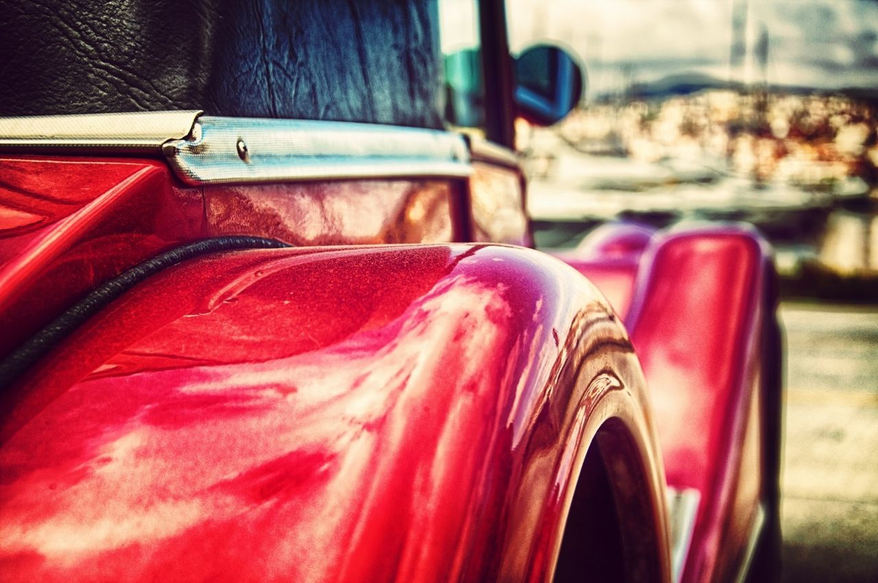 Hubcap of red vintage car in detail