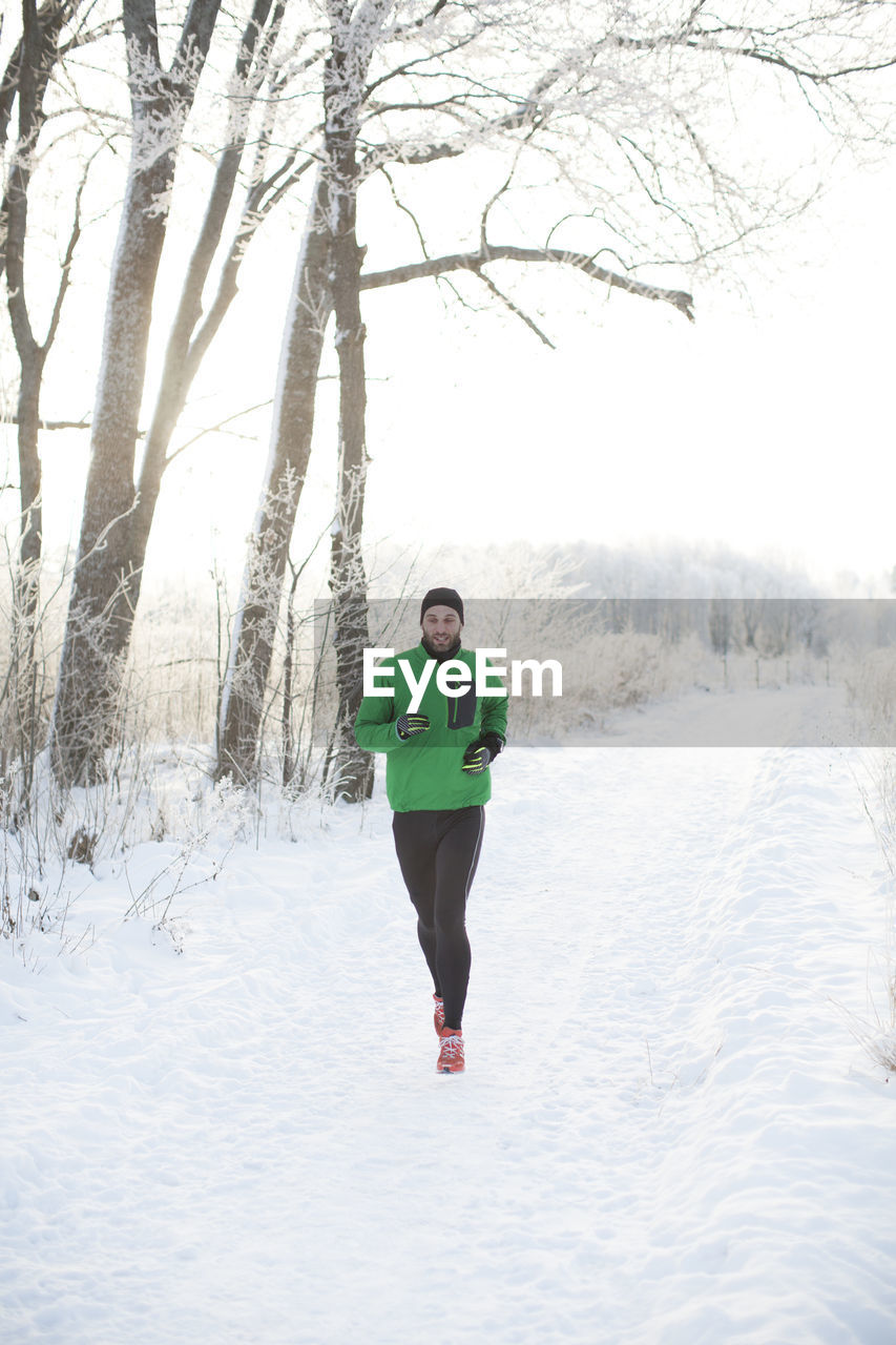 Mid adult man running at winter