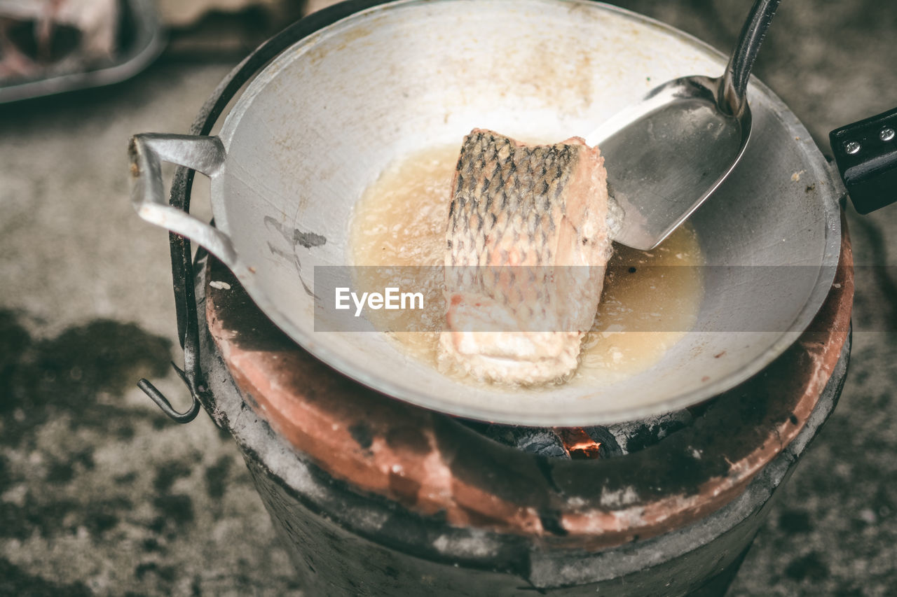 High angle view of meat frying in container