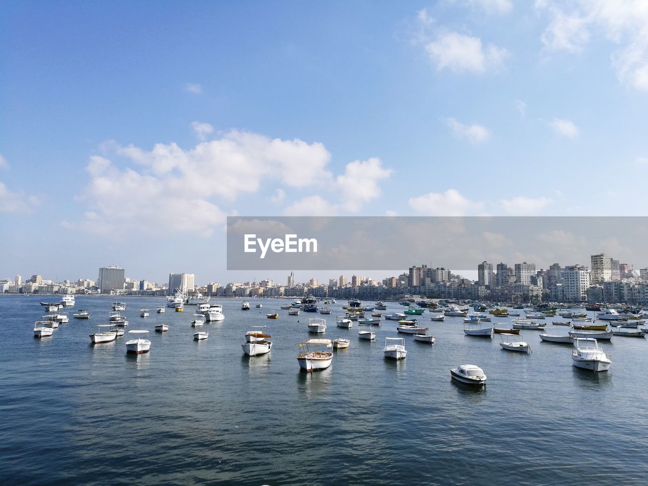 Sailboats in sea against sky
