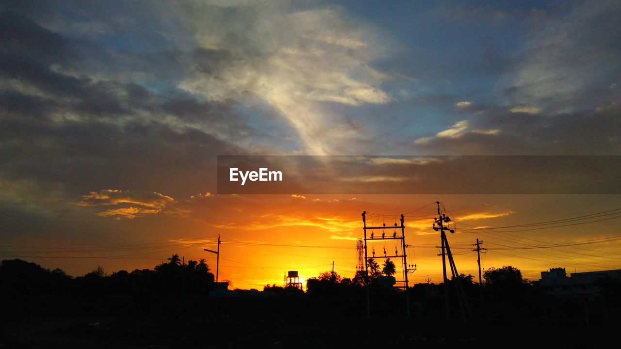 SILHOUETTE ELECTRICITY PYLON AGAINST SKY DURING SUNSET