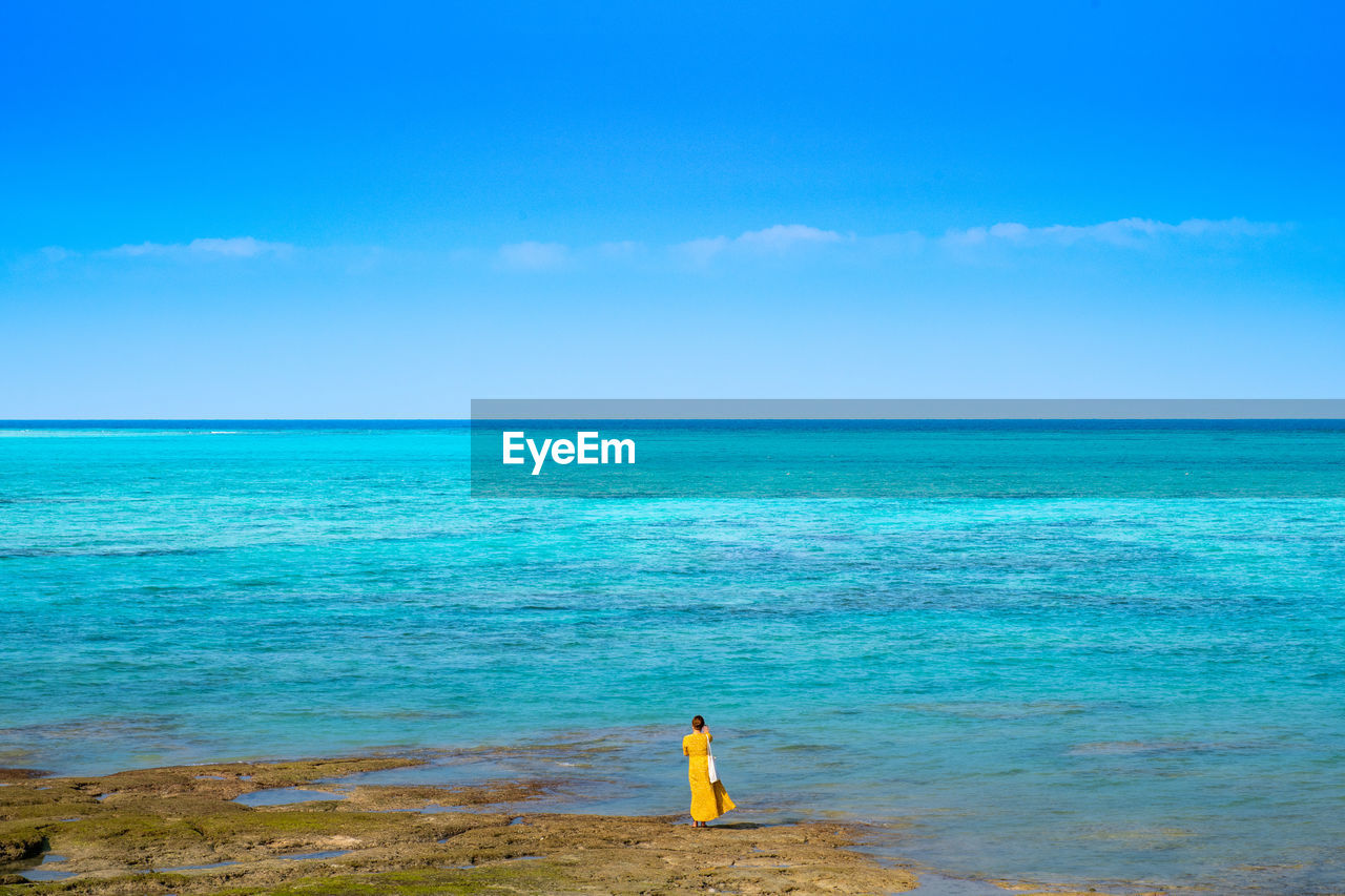 Rear view of sea against sky