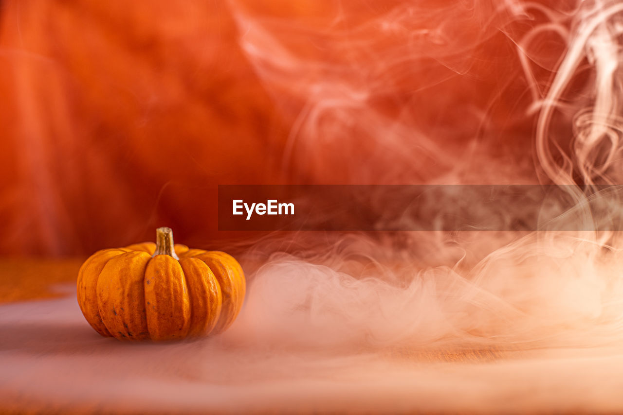 Close-up of pumpkin against orange background