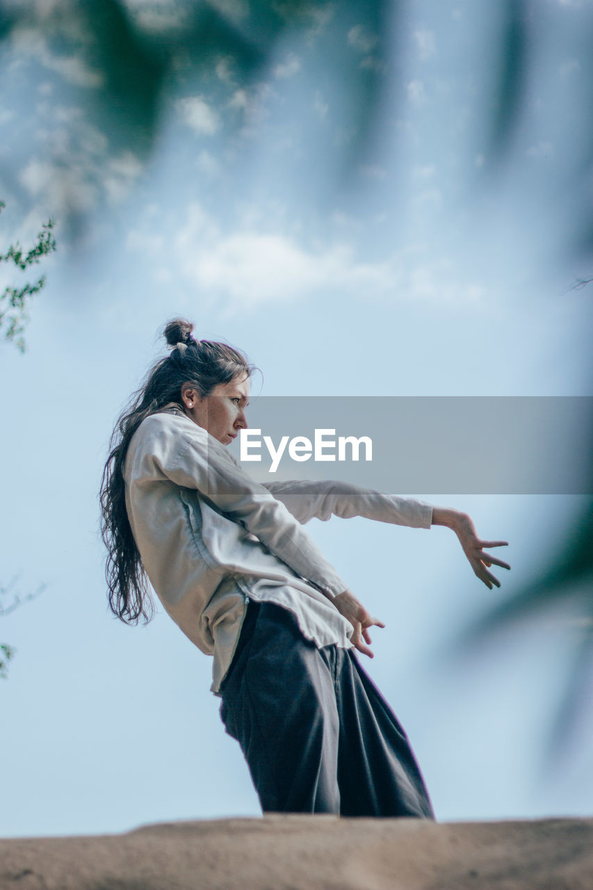 Woman dancing in forest