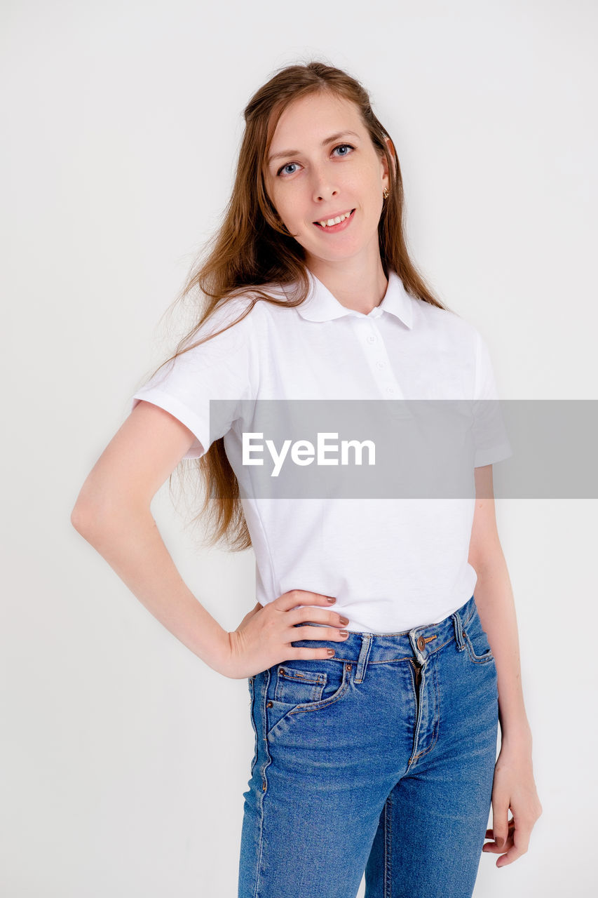 portrait, one person, women, studio shot, looking at camera, casual clothing, smiling, sleeve, adult, indoors, young adult, happiness, clothing, long hair, hairstyle, jeans, white background, emotion, standing, pocket, three quarter length, photo shoot, fashion, female, t-shirt, cheerful, front view, relaxation, cut out, positive emotion, brown hair, teeth, child, blouse, collar, denim, smile, lifestyles, copy space, white, cute, enjoyment, hands in pockets