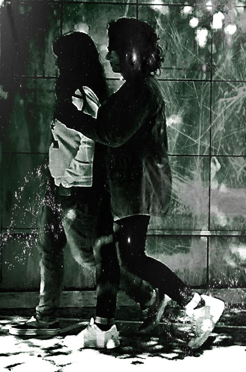 YOUNG WOMAN STANDING IN PARK