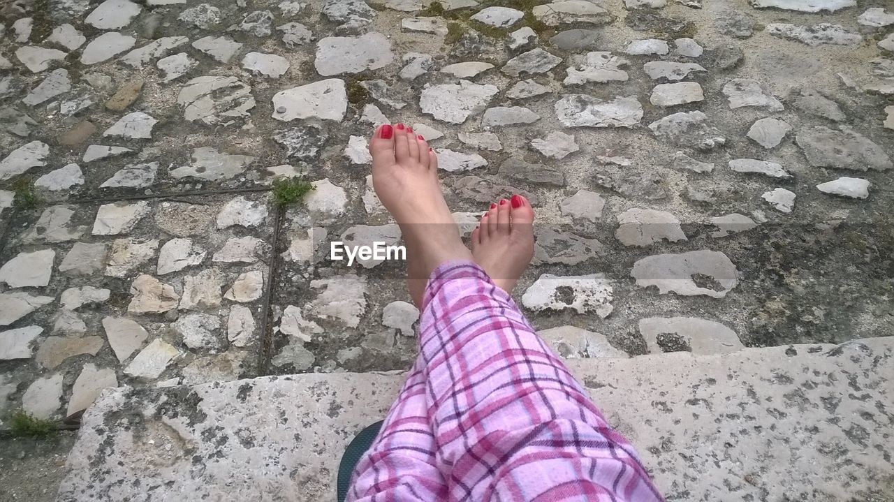 Low section of woman sitting on steps