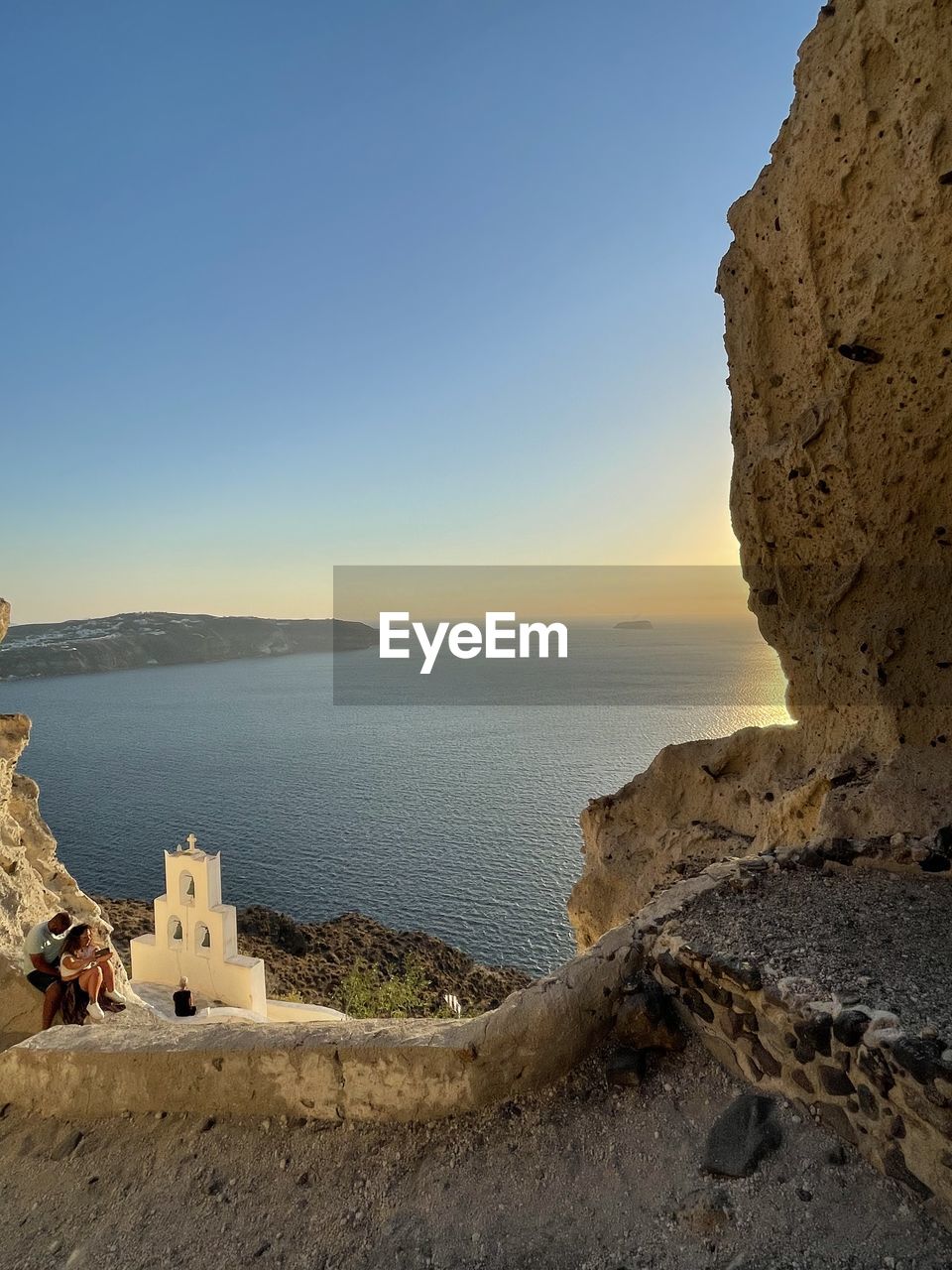 nature, water, rock, sky, scenics - nature, beauty in nature, no people, land, rock formation, terrain, reflection, architecture, sea, day, cave, outdoors, cliff, travel, sunlight, travel destinations, environment, tranquility, blue, clear sky, landscape, non-urban scene, arch, beach, mountain, formation, built structure