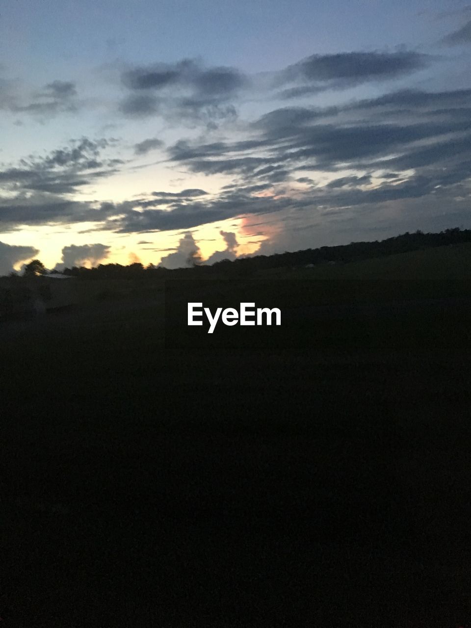 SCENIC VIEW OF SILHOUETTE FIELD AGAINST SKY DURING SUNSET