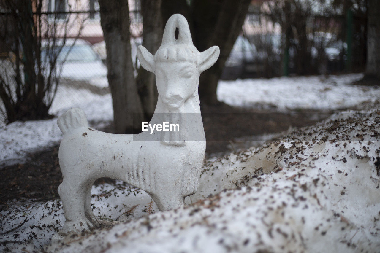 snow, winter, white, cold temperature, statue, representation, tree, freezing, nature, sculpture, no people, day, plant, human representation, land, focus on foreground, animal representation, outdoors, craft, ice, tree trunk, creativity, art, frozen, selective focus, trunk