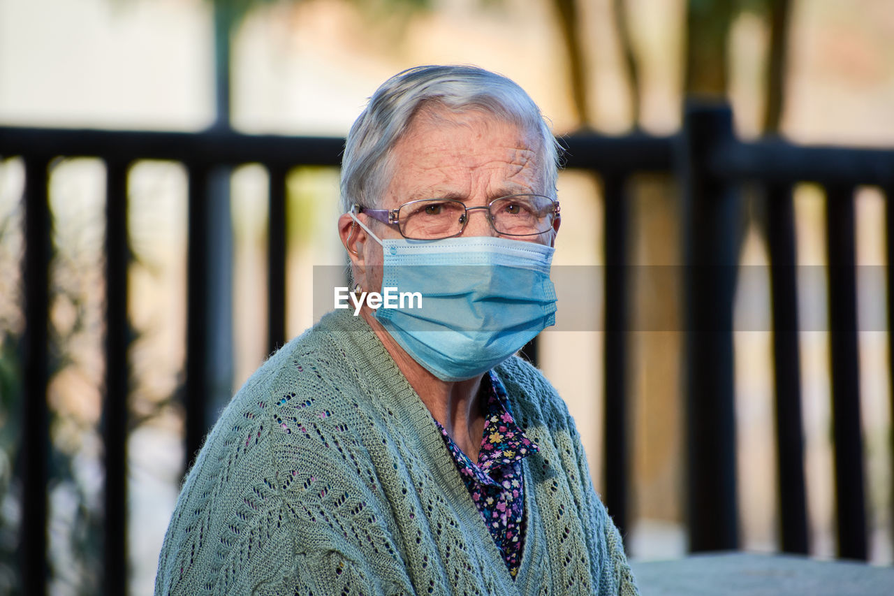 Close-up portrait of an older woman wearing a mask person