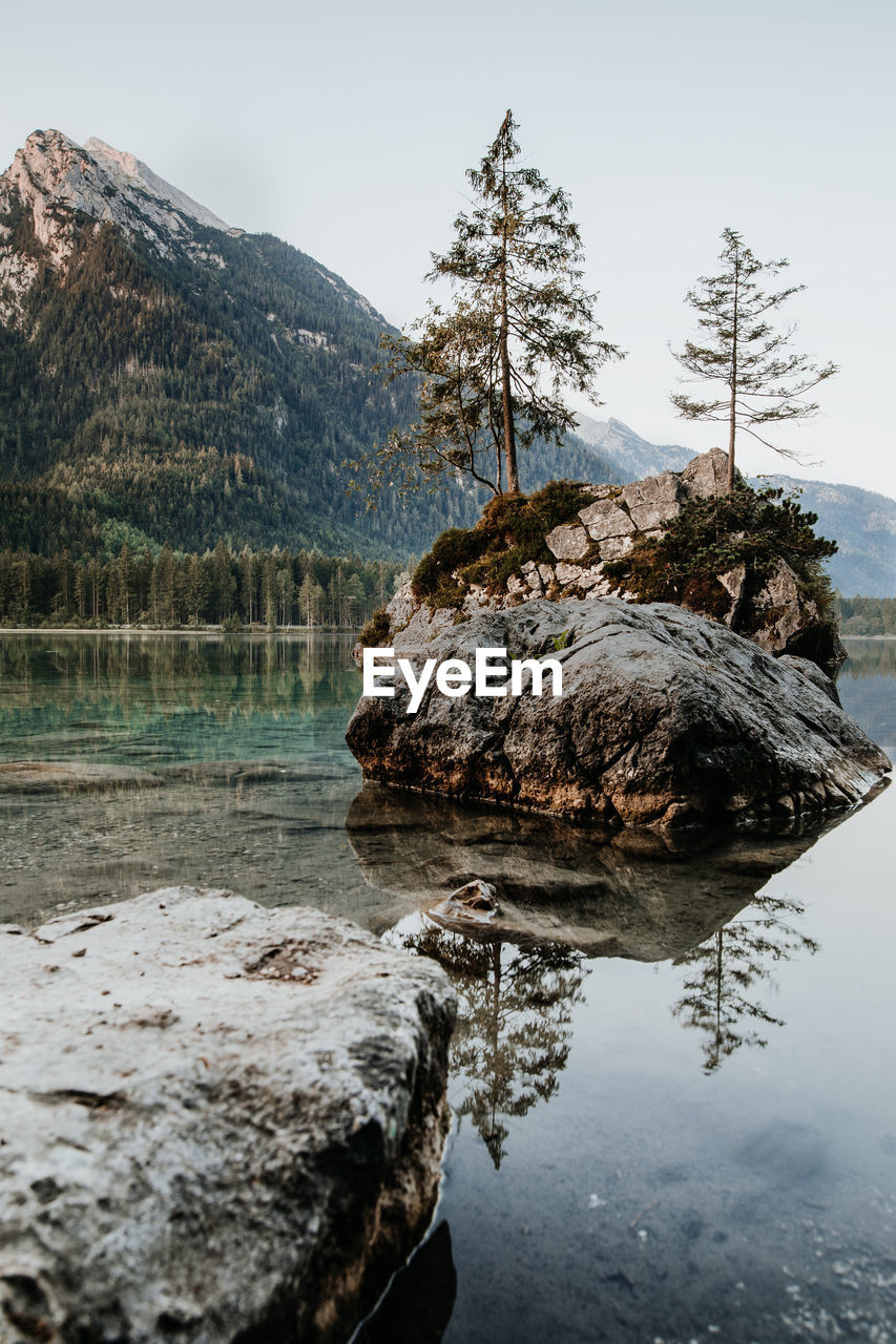 Rocks in lake against sky