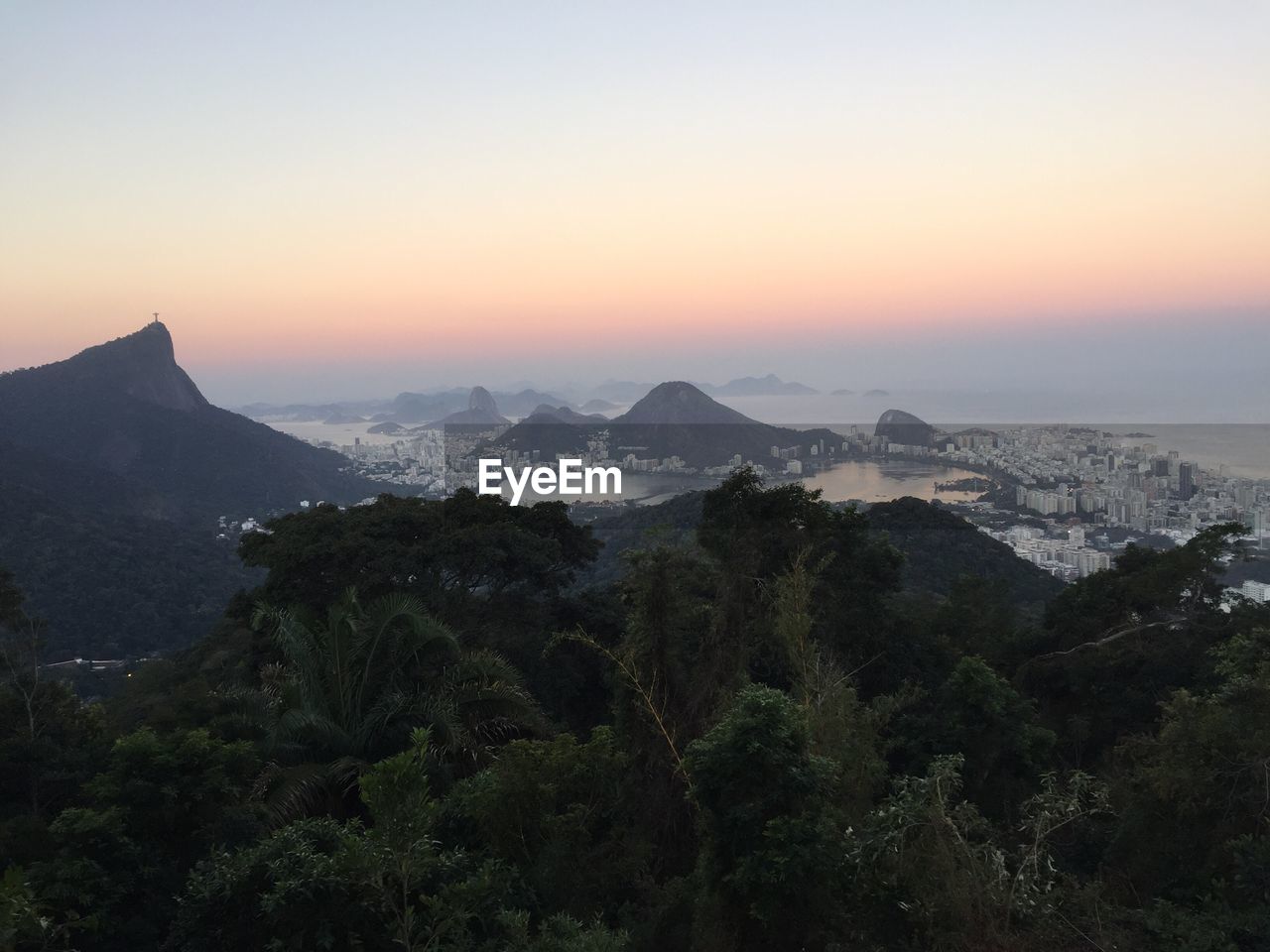 SCENIC VIEW OF TREE MOUNTAINS AGAINST SKY DURING SUNSET