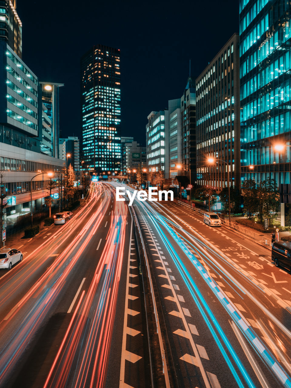 Light trails on road along buildings at night