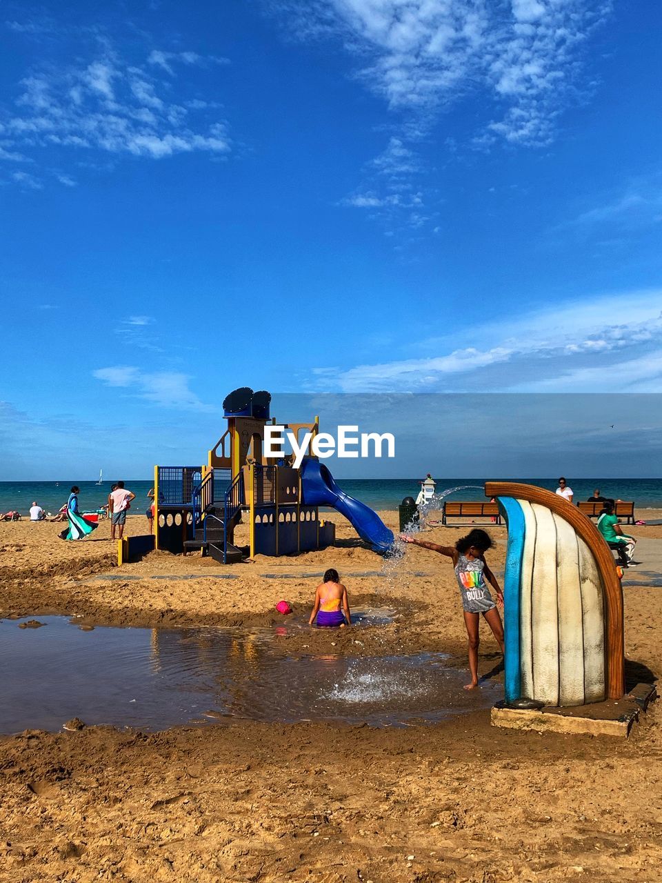 PEOPLE ON BEACH AGAINST SKY